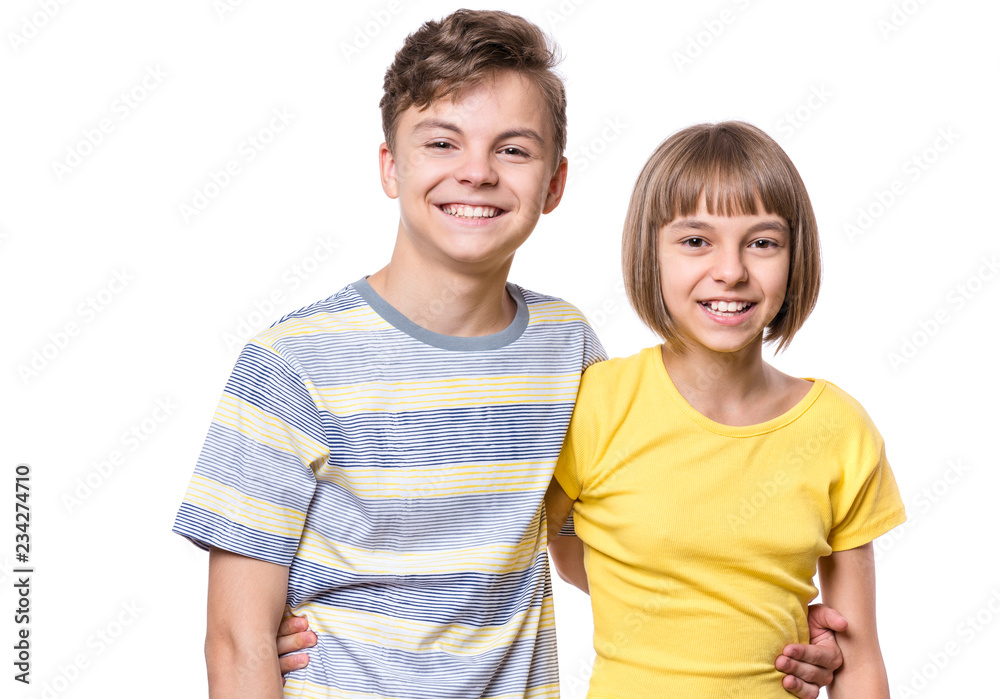 Portrait of happy boy and girl hugging. Cute brother and sister isolated on white background. Funny couple children laughing with a perfect smile. Portrait of happy boy and girl hugging. Cute brother and sister isolated on white background. Funny couple children laughing with a perfect smile.