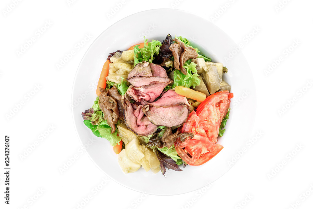 Salad with meat, pear, tomato, on a white plate isolated on white background isolated on white background. top view. flat lay