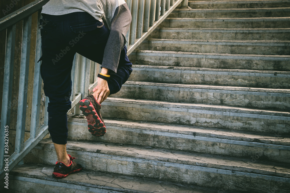 Runner man holding ankle in pain. Athlete runner training accident. Runner man holding ankle in pain. Athlete runner training accident.