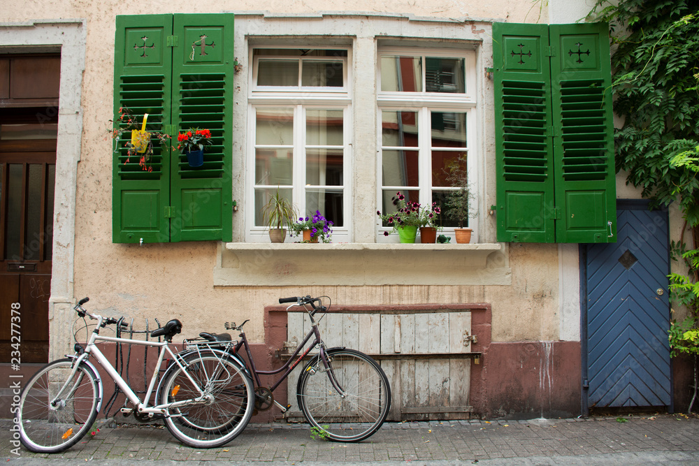 German people stopping and lock bicycle at front of classic and retro house in Heidelberg, Germany