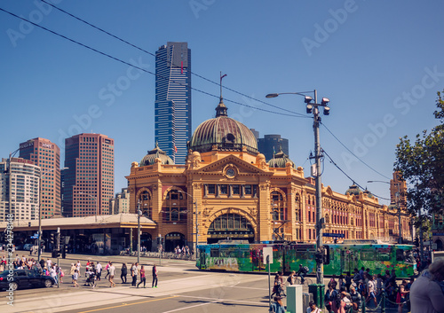 People are crossing the road in front of the Flinders Street Station in Melbourne CBD, Australia. 