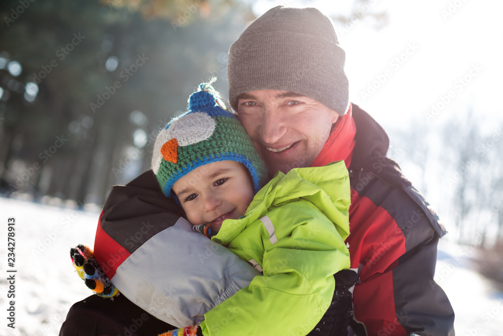 Fototapeta premium Granddad hugging his cute grandson