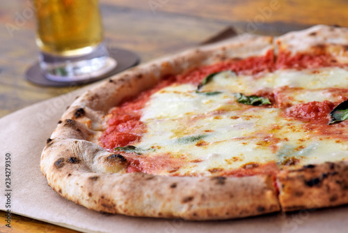 Pizza Margherita on rustic wooden table