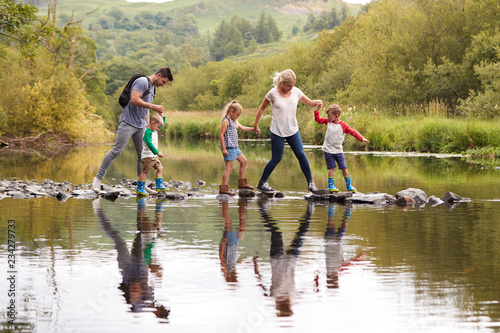 Принти на полотні Family Crossing River Whilst Hiking In UK Lake District