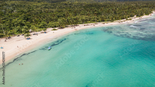 View of the ocean coast beach and mountains. Secluded white sand beach and mountains. Summertime Sea tranquility. Aerial view © Irina