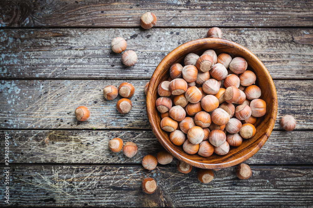Natural hazelnut in a wooden bowl Natural hazelnut in a wooden bowl
