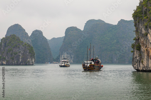 Halong Bay, Vietnam. Unesco World Heritage Site. Traditional tourist boats.