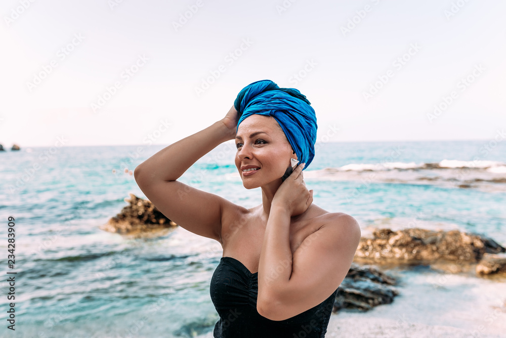 Summer vacation concept. Young fashionable woman on the rocky sea shore. Summer vacation concept. Young fashionable woman on the rocky sea shore.