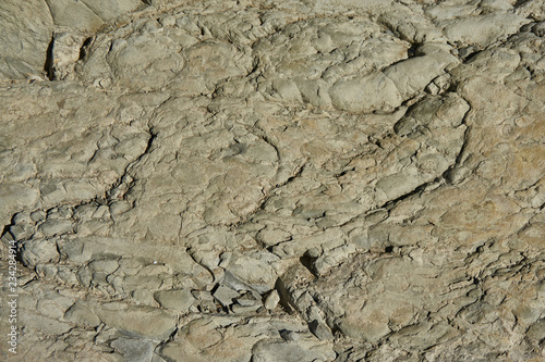 Mountain stone with a natural texture as a design concept. Cracks created by nature on the surface of the stone with a natural color scheme  create a natural textured background. Texture for design .