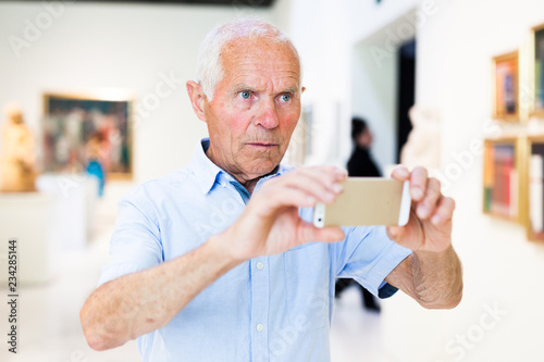 Wallpaper Mural Man photographing painting in museum Torontodigital.ca