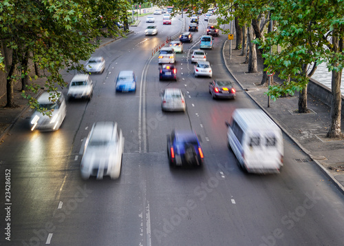 traffic on a four lane city street at evening