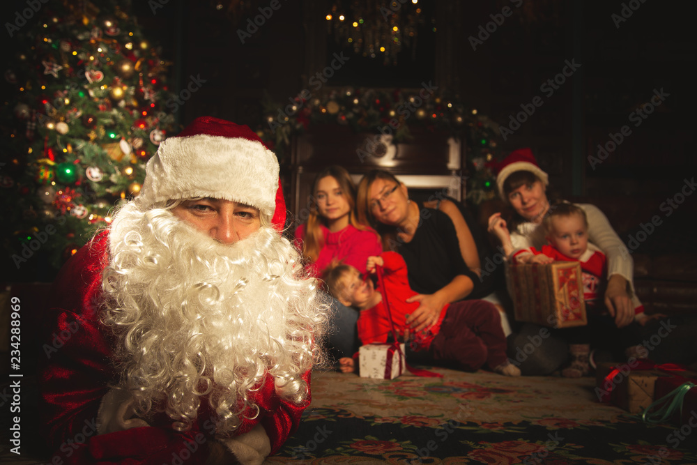 Christmas family portrait in a festive living room with a real Santa Claus. Christmas family portrait in a festive living room with a real Santa Claus.