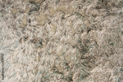 Texture brown towel background. Closeup of damage, beat-up and old plush terry texture.