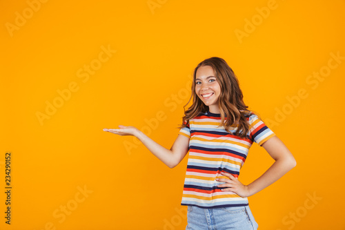 Portrait of a cheerful young girl presenting copy space