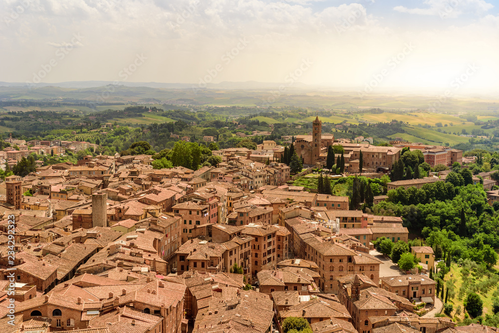 Historic town Siena, Tuscany - Aerial view with beautiful landscape scenery on a sunny summer day, walled medieval hill town with towers in the province of Siena, Italy- Europe