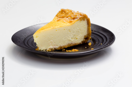 Cheesecake on black saucer photo