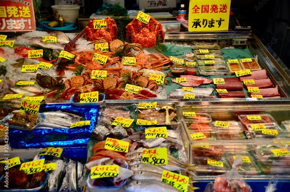 Fototapeta premium Raw fish and sea food oyster sea shell squid crab and prawn on the ice in Tsukiji Fish market in Tokyo,Japan 