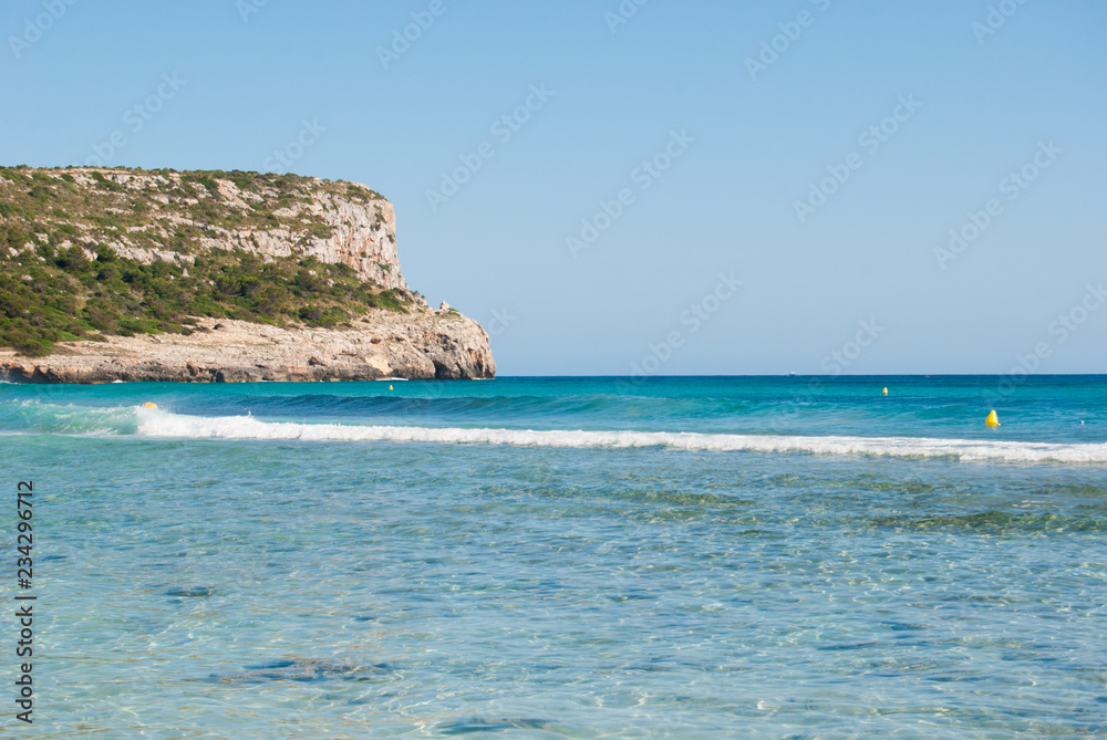Cape of Son Bou bay with crystalline sea