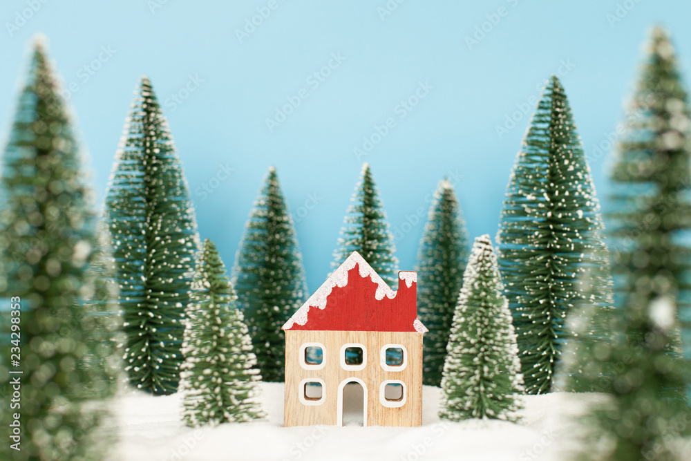 Fototapeta Landscape forest with christmas trees and house on the snow in winter. Concept of christmas holiday celebration and new year