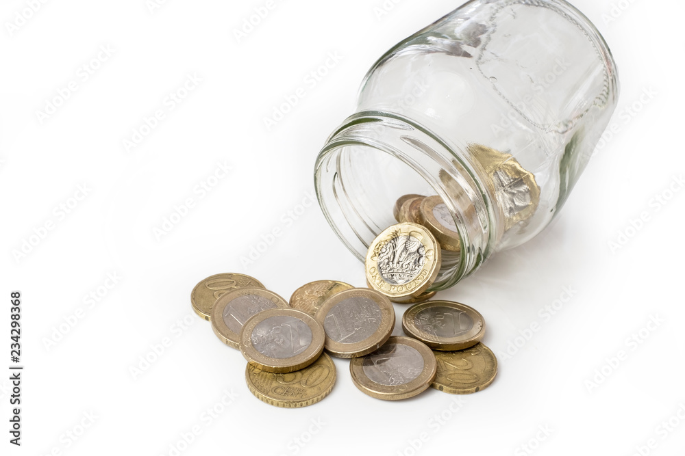 UK money falling from jar, changing ito euro coins UK money falling from jar, changing ito euro coins
