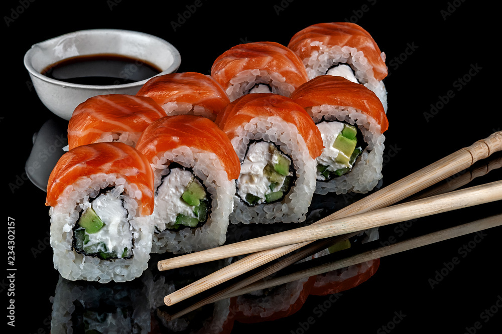 Philadelphia sushi rolls with chopsticks