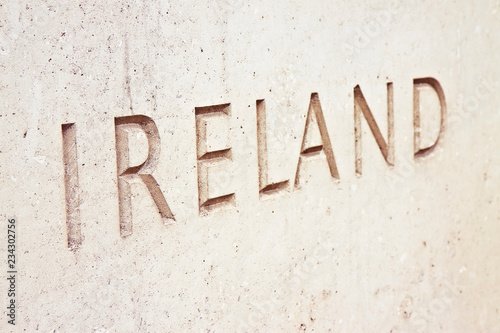 The word  Ireland  carved on stone wall - image with copy space