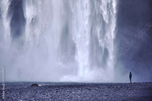 waterfall Skógafoss and man  photo