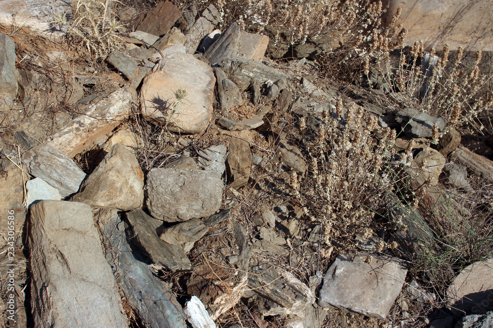 Rubble debris from abandoned stone house evia island greece rocks and dry vegetation Rubble debris from abandoned stone house evia island greece rocks and dry vegetation
