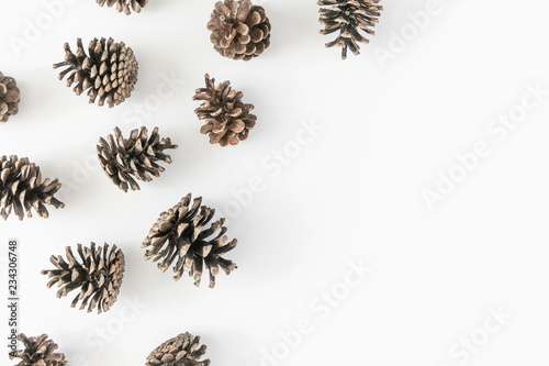 Christmas creative composition. Pine cones pattern on white background. Christmas, New Year, winter concept. Flat lay, top view, copy space 