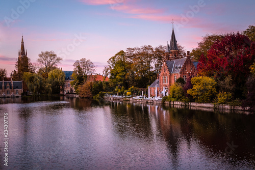 Brugge's canal Castel on river side under beautiful sunset light. Worm temperature. 