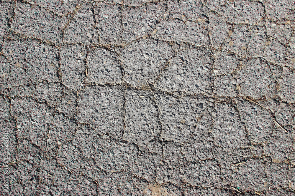 Old asphalt surface texture detail with cracks fractures lines close up Old asphalt surface texture detail with cracks fractures lines close up