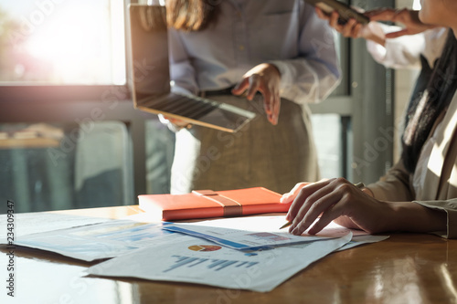 Close up business team data analyzing income charts document during discussion explain strategy meeting. on start-up project teamwork together photo