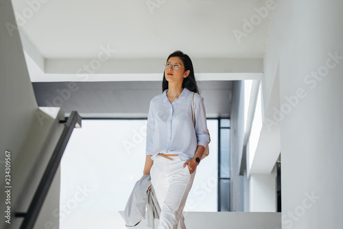 Portrait of beautiful elegant young Asian businesswoman walking. photo