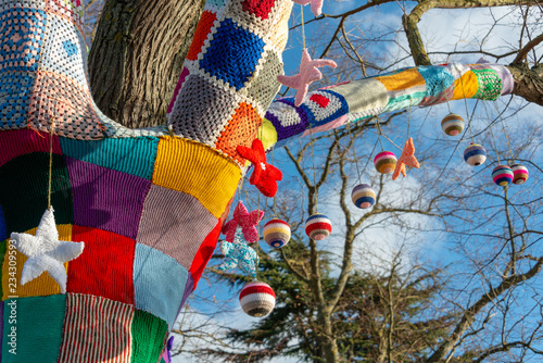 branch of tree with Christmas knitted yarn bomb photo