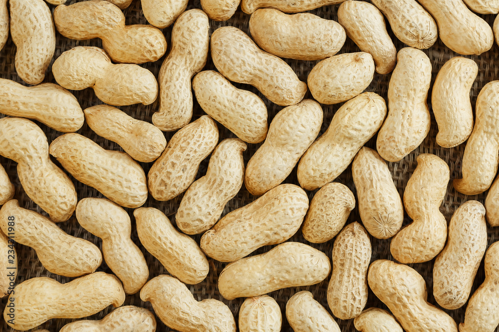 Peanuts in their shell textured food background. Peanuts in their shell textured food background.