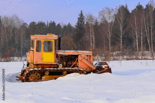 Winter sceneries, old tractor under the snow