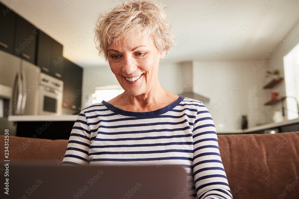 Senior white woman using laptop computer at home, close up Senior white woman using laptop computer at home, close up
