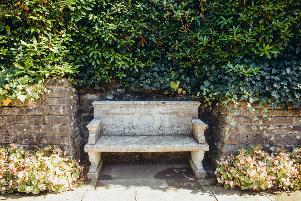 Ancient stone bench in a park surrounded by foliage and hedge. Traditional  Italian style park exterior. Selective focus, copy space. Stock Photo |  Adobe Stock