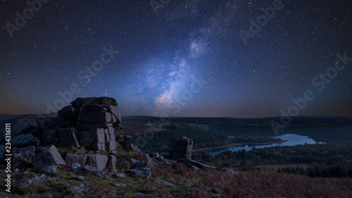Stunning vibrant Milky Way composite image overStunning Autumn sunset landscape image of view from Leather Tor towards Burrator Reservoir in Dartmoor National Park