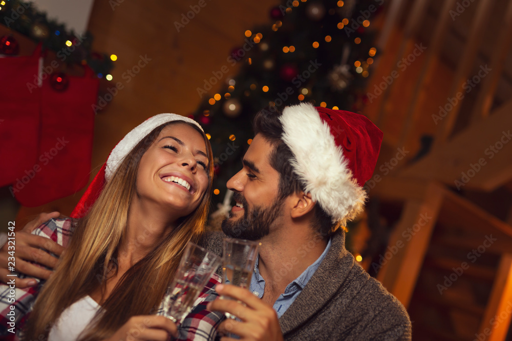 Couple drinking champagne on Christmas Eve