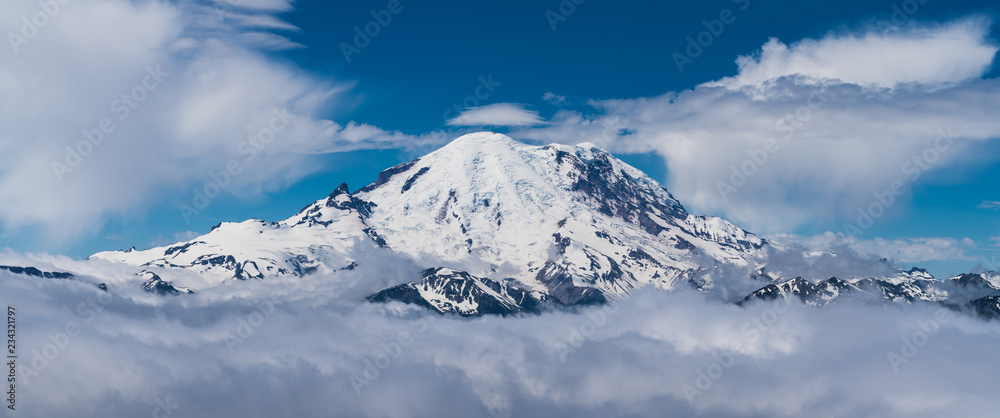 clear snowy mountain peak in the clouds