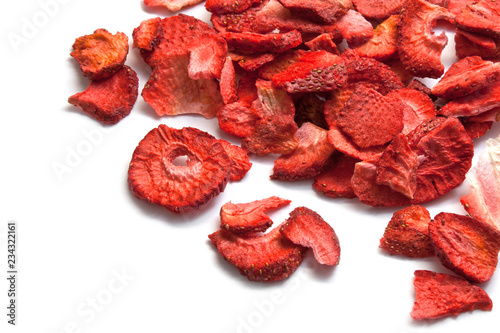 Sliced dried strawberries isolated on white photo