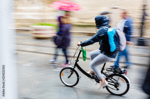 bicycle rider in the rainy city