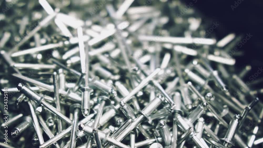 Closeup of metallic new rivets in a container. Macro shooting of metal rivets with changing sharpness zone. Closeup of metallic new rivets in a container. Macro shooting of metal rivets with changing sharpness zone.