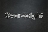 Healthcare concept: text Overweight on Black chalkboard background