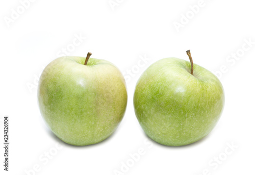 Two juicy green apples isolated on a white background. Side view