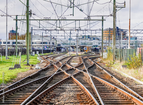 Fotografie An abstract view of railway tracks leading to a busy station.