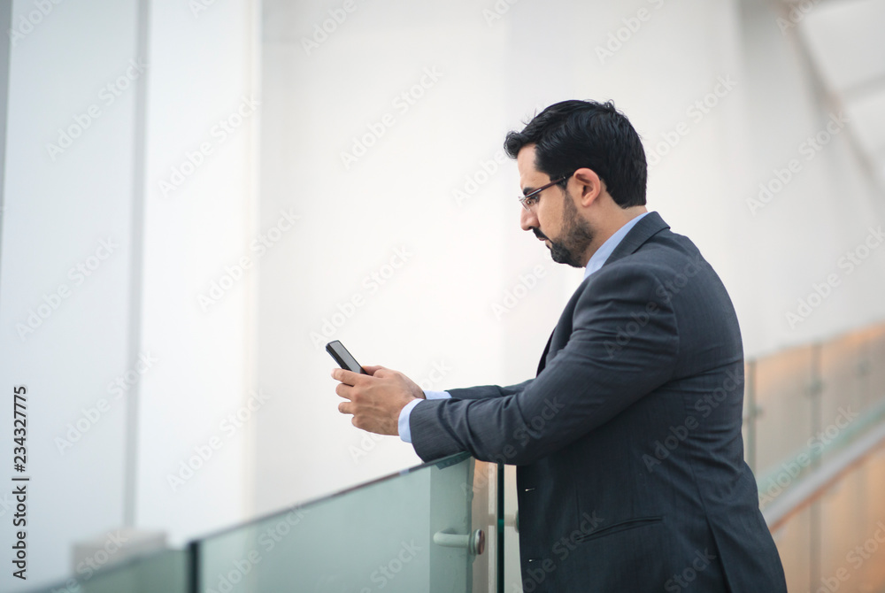 arab business man texting on his phone arab business man texting on his phone