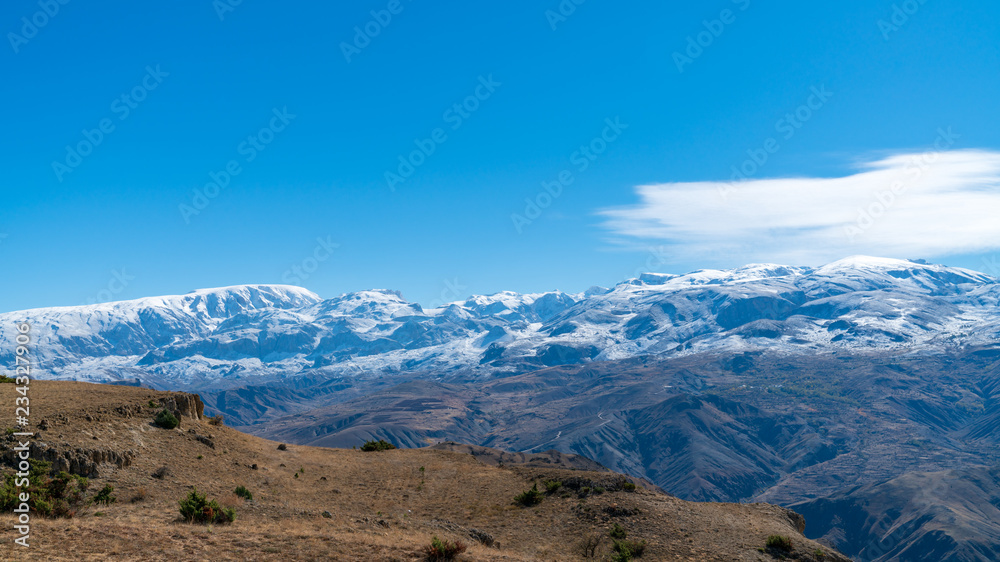 Panoramic view of a valley with snow capped mountains near Erzincan, Turkey