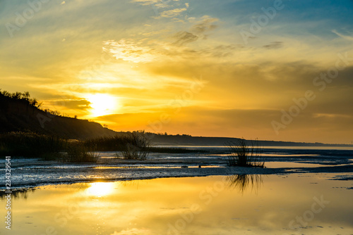 The sea and the beautiful expanse of blue sky with clouds and sunlight at sunset. Russia Azov sea.